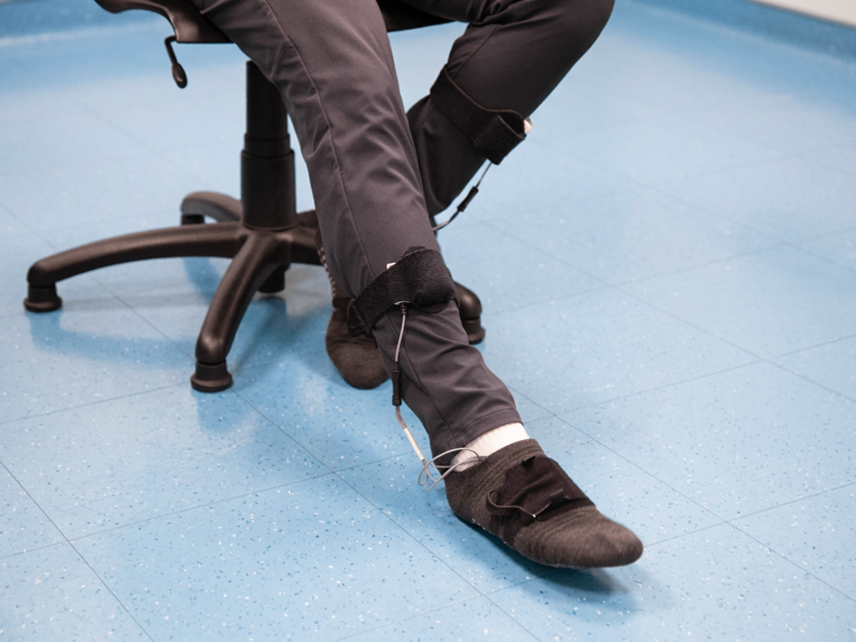 Participant wearing lower-leg experimental instrumentation during a controlled human-subject research session.